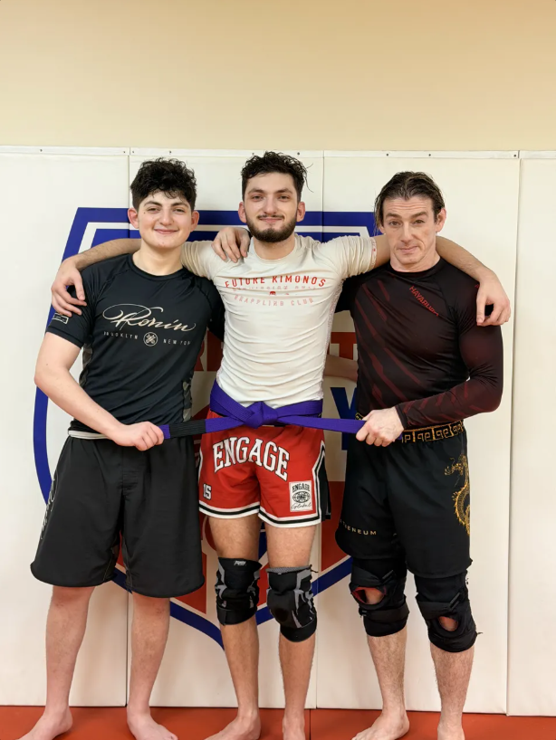 Josh receiving his purple belt from coach Eugene Sakirski